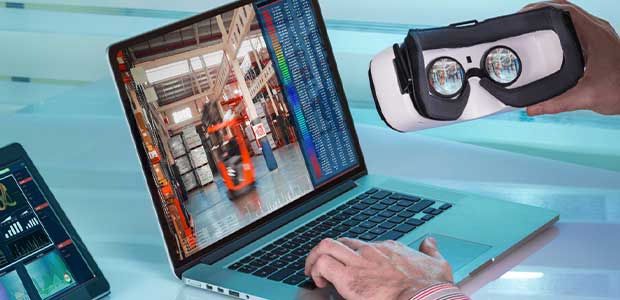 person holding virtual reality glasses while looking at video on computer of forklift in warehouse