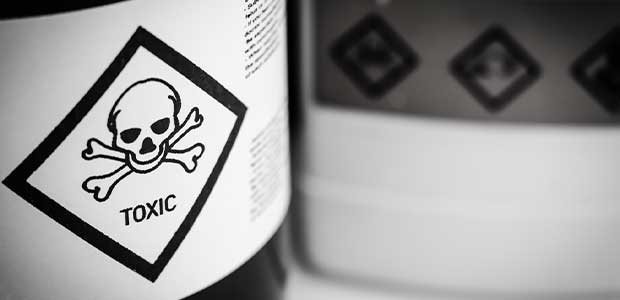 close up of bottle with "toxic" warning label, which has a skull and crossbones, on the side